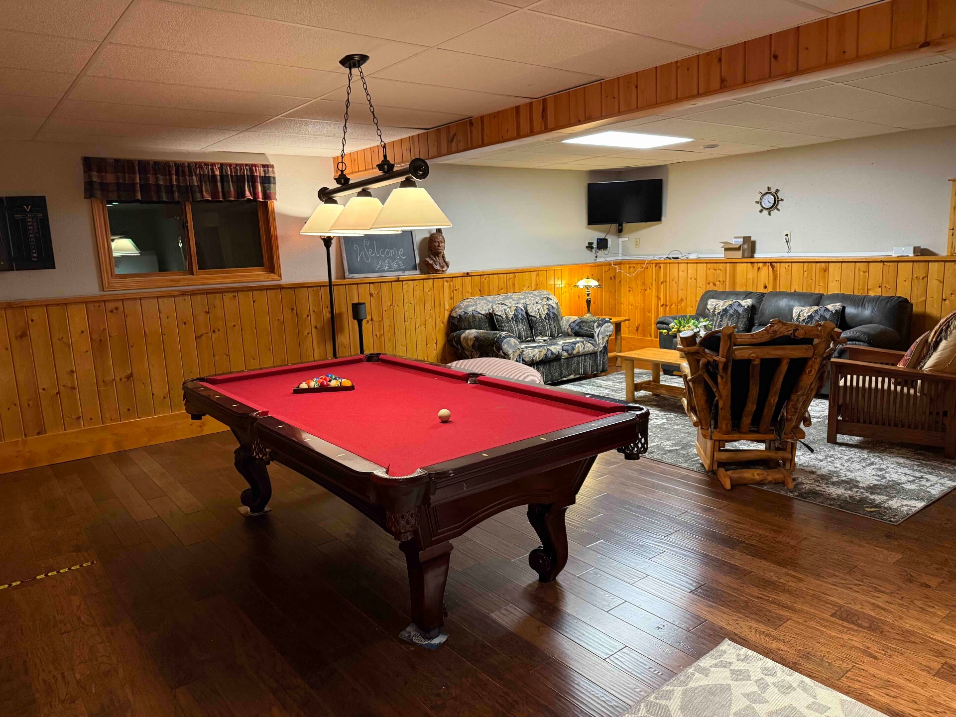 Game room with pool table and rustic seating